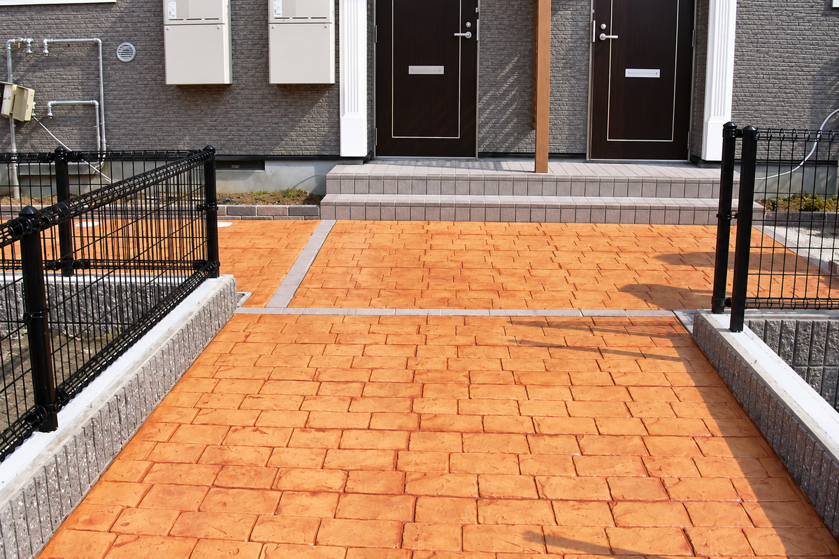 How Orange Stamped Concrete Brings Warmth to a Modern Home Entrance