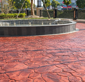 Framing the Fountain: Red Stamped Concrete Design